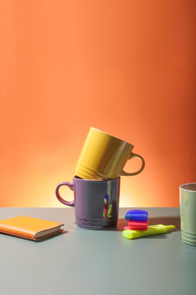 drinking cups, mugs, cups, notebook, pens