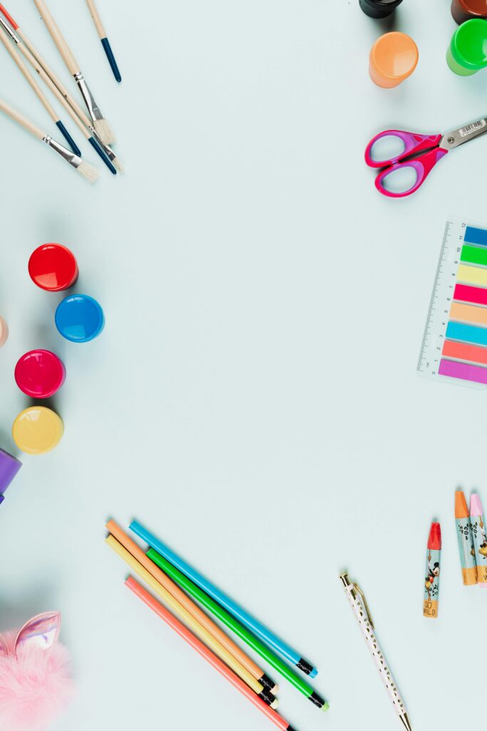 Colorful arrangement of art supplies with copyspace for creative projects.